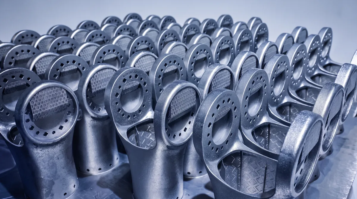 Topology-optimized metal 3D printed parts with diamond lattice infill fresh off an LPBF build plate